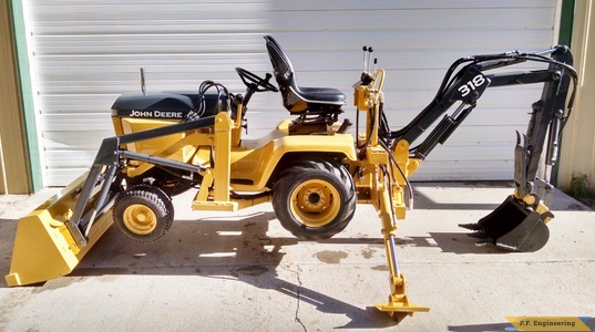 John Deere 318 Micro Hoe getting air by Jake T.